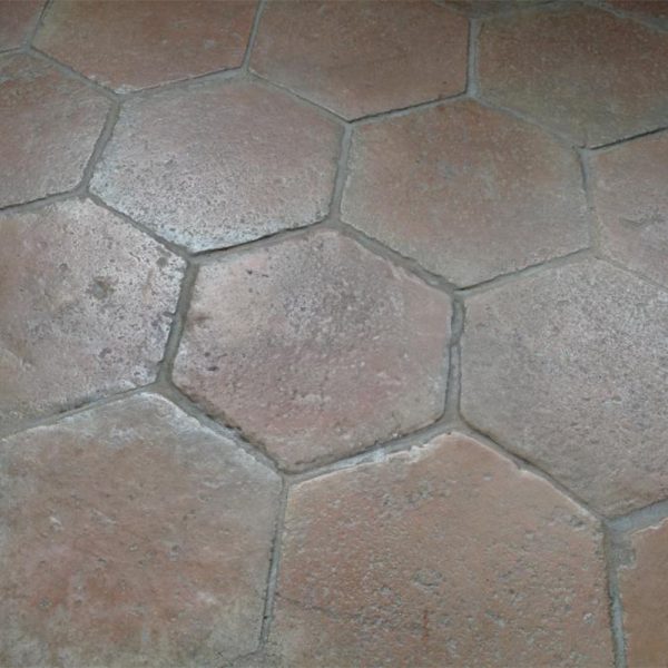 flooring in large antique hexagonal terracotta tiles
