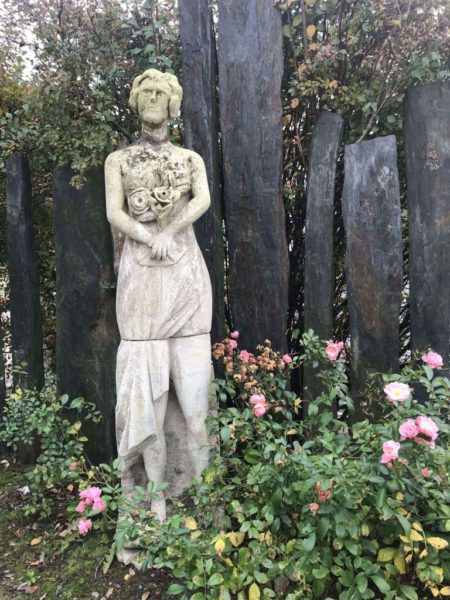 antique statue of a women with flowers