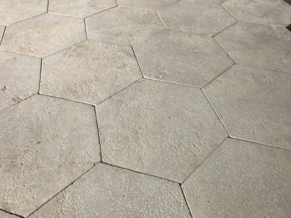 Antiqued limestone hexagon tiling