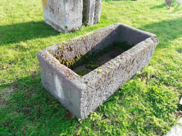 ancient or old grey stone trough