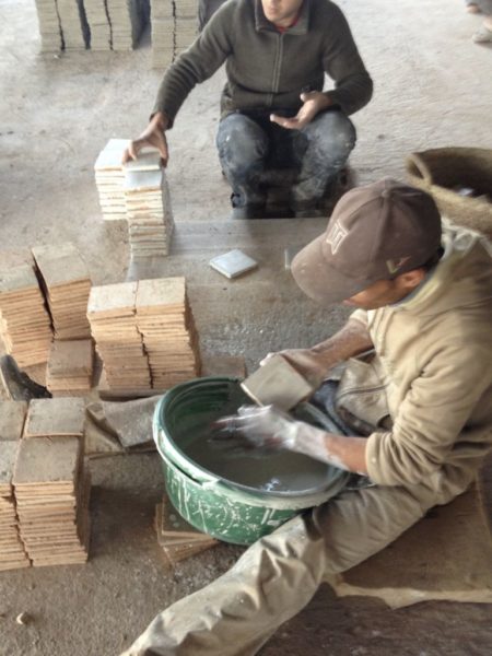 Applying zelliges glaze in Morocco