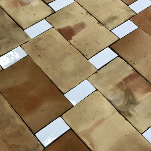 reclaimed terracotta floor with white rectangulat glazed tiles