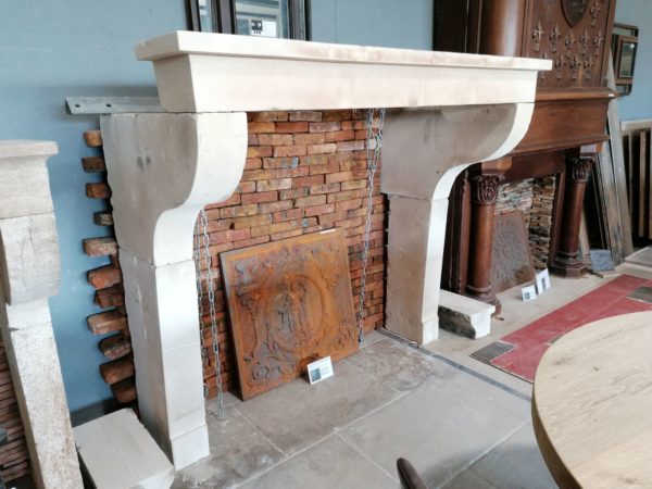 antique farmhouse fireplace mantel in showroom