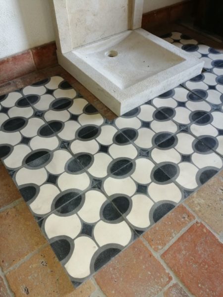 oval pattern with black, grey and beige cement tile