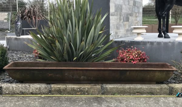 long antique cast iron trough for horses