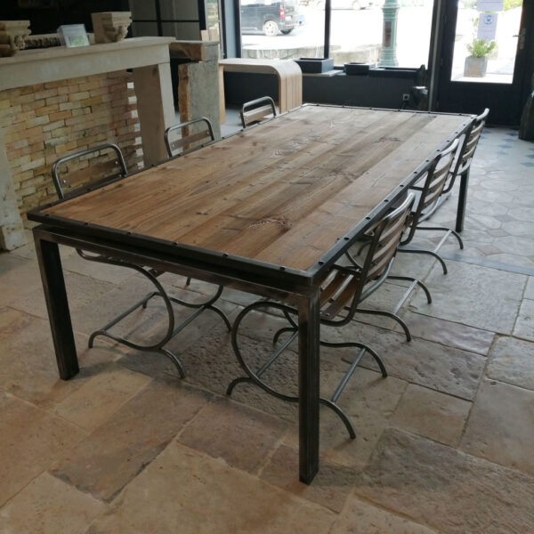 large metal table with pine at the top