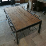 large metal table with chair and pine