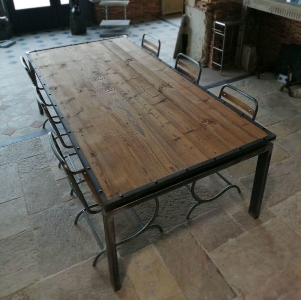 large metal table with chair and pine