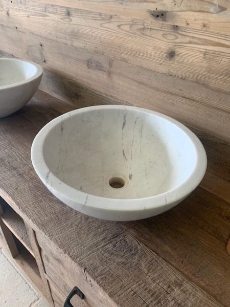 rounded white limestone washbasin