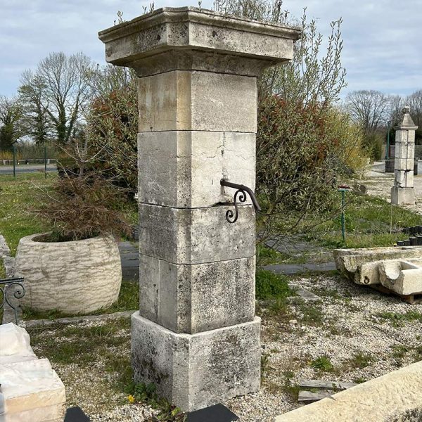 Antique limestone column support for statue