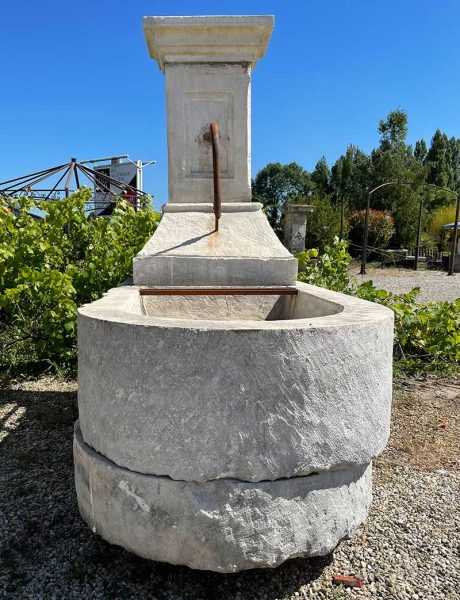 French stone fountain with a classic colulmn