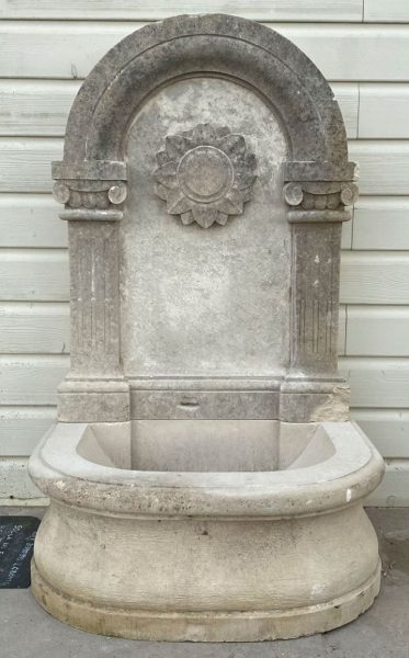 Wall fountain with a flower