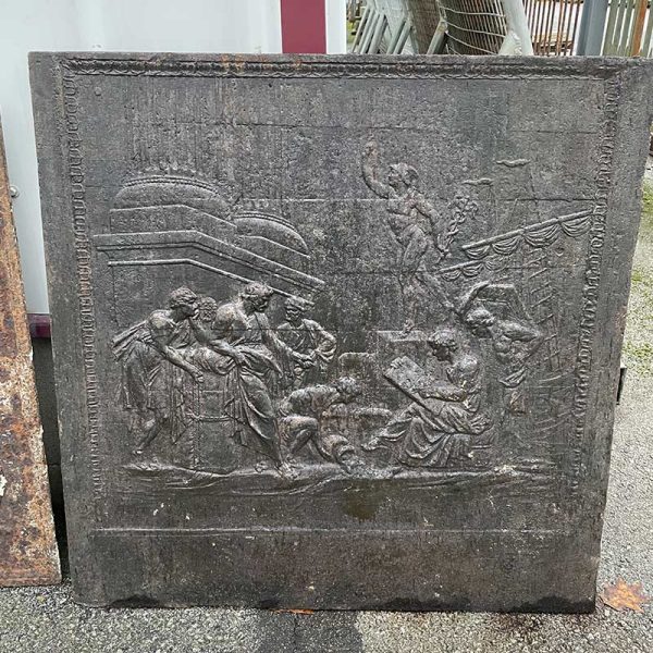 Antique french fireback with traders at the port