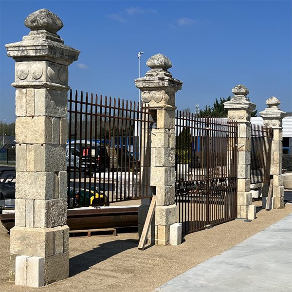 Monumental entrance with pillars gates and railings