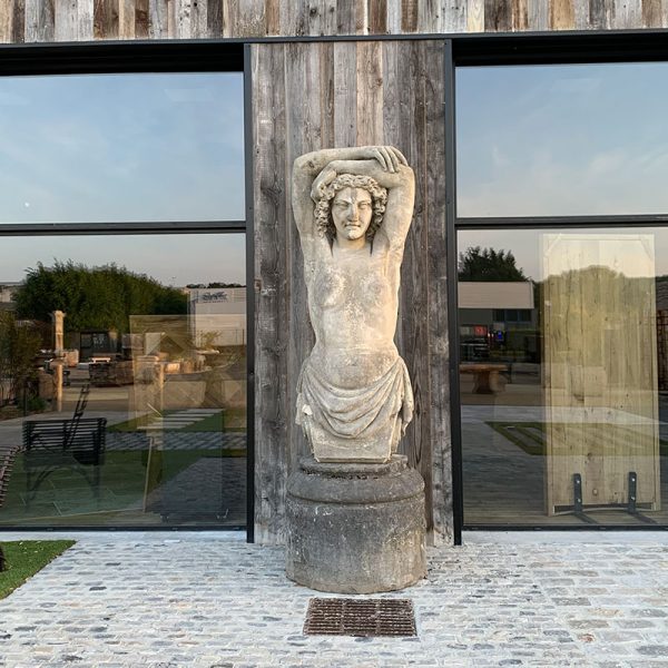Antique limestone female statue outside