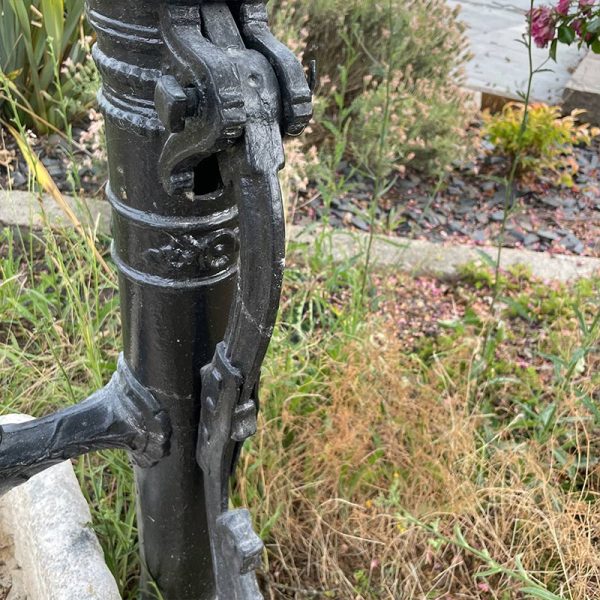Vintage cast iron water pump with charming decorative details.