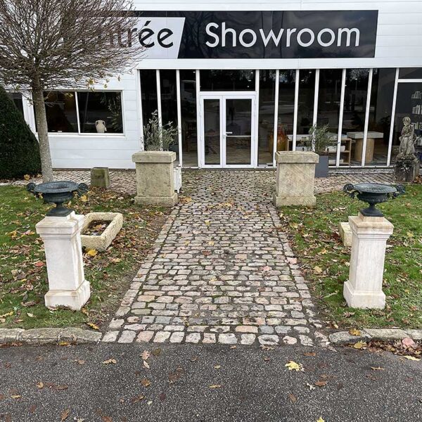 pair of stone columns with cast iron vases