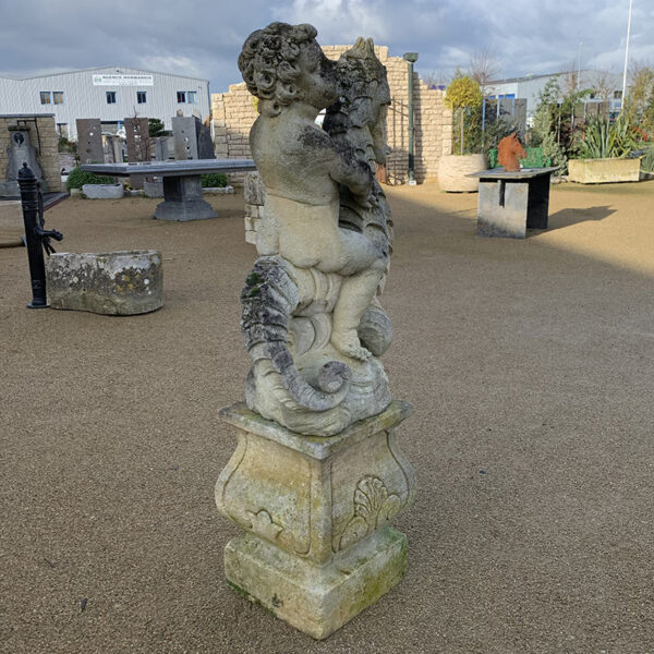 Statue of Neptune Poseidon emerging from water with seahorse