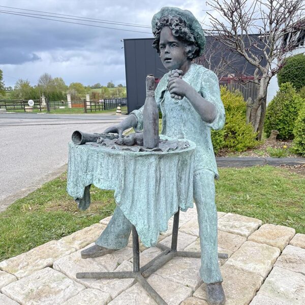 statue ancient boy sitting at table