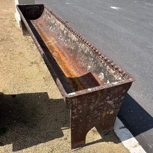 antique iron trough on stand