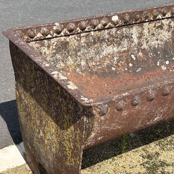 antique iron trough with rivets