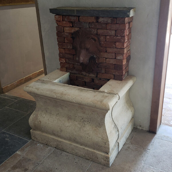 small wall fountain in natural stone