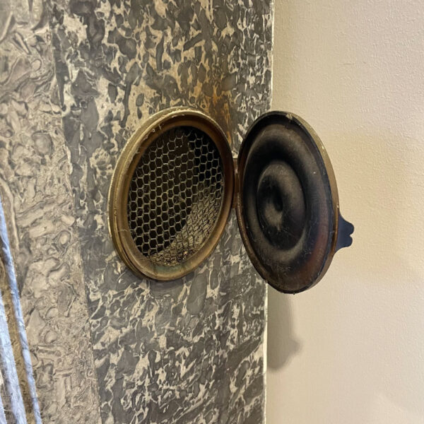 Gray marble fireplace with damper and grille