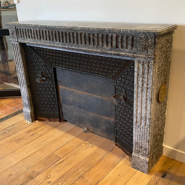 gray marble fireplace with fireback