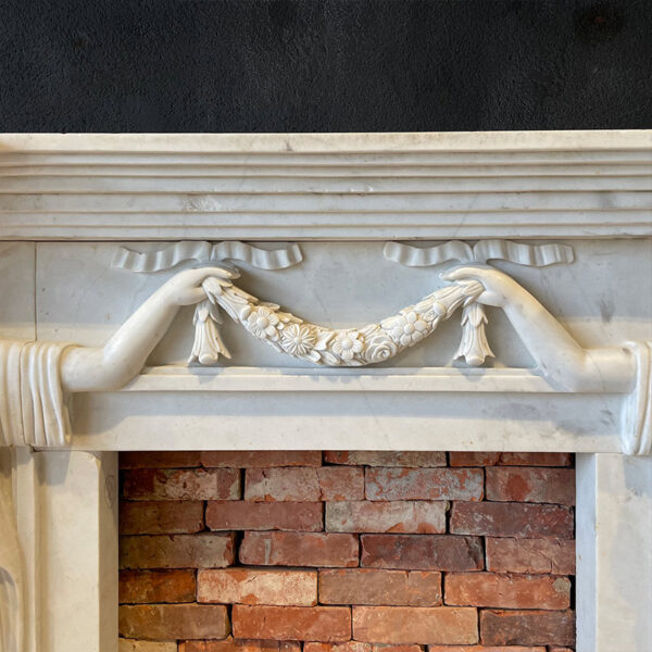Withe marble fireplace with flower garland