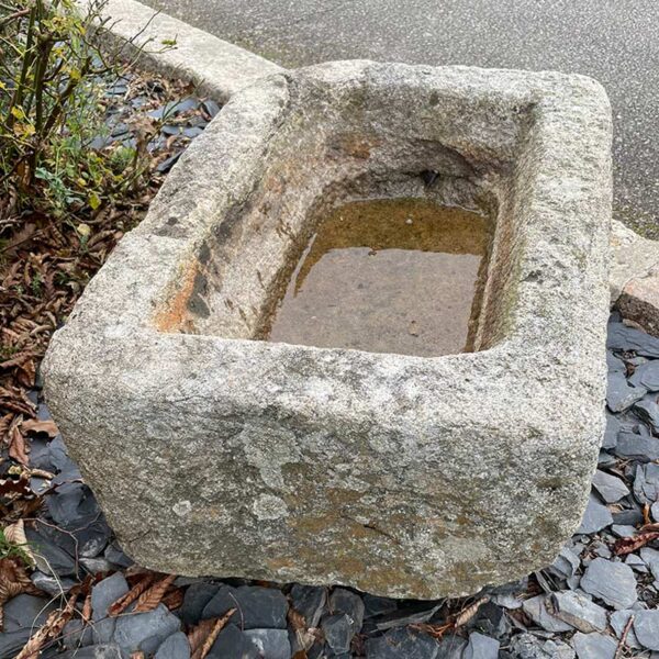 antique granite trough with raw appearance