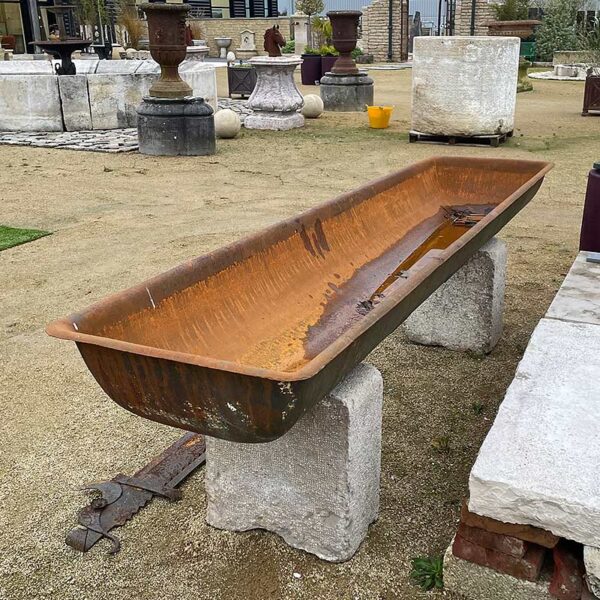 cast iron trough with rust colored patina