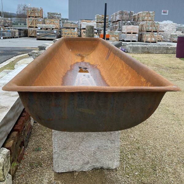large cast iron trough on natural stone