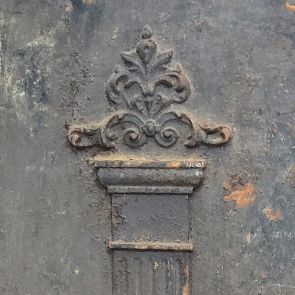 pilaster capital on antique cast iron fireback