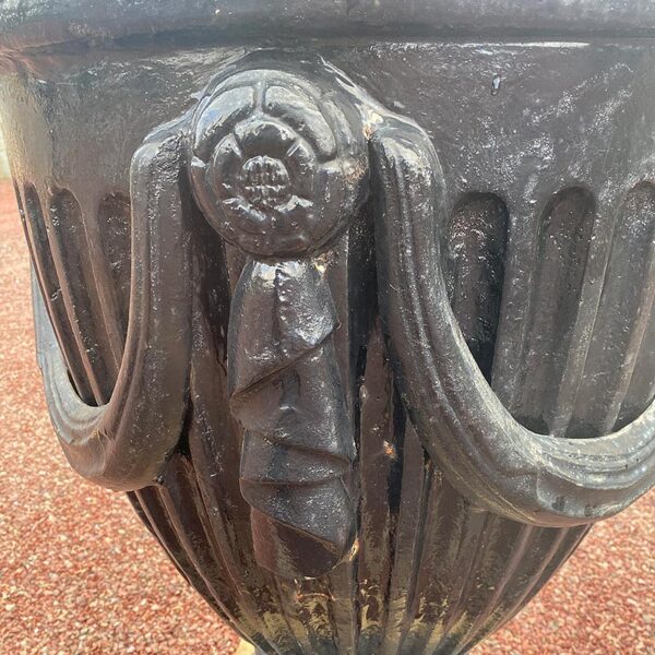 antique cast iron urn with rosettes
