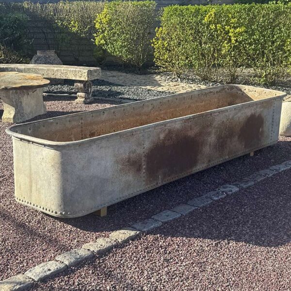 antique iron trough with rivets