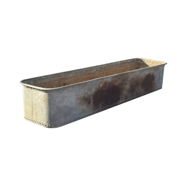 large iron trough with rivets