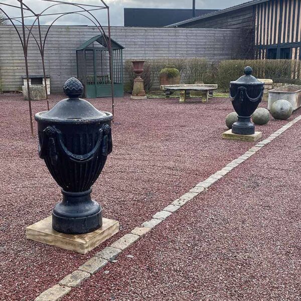 two antique black cast iron urns
